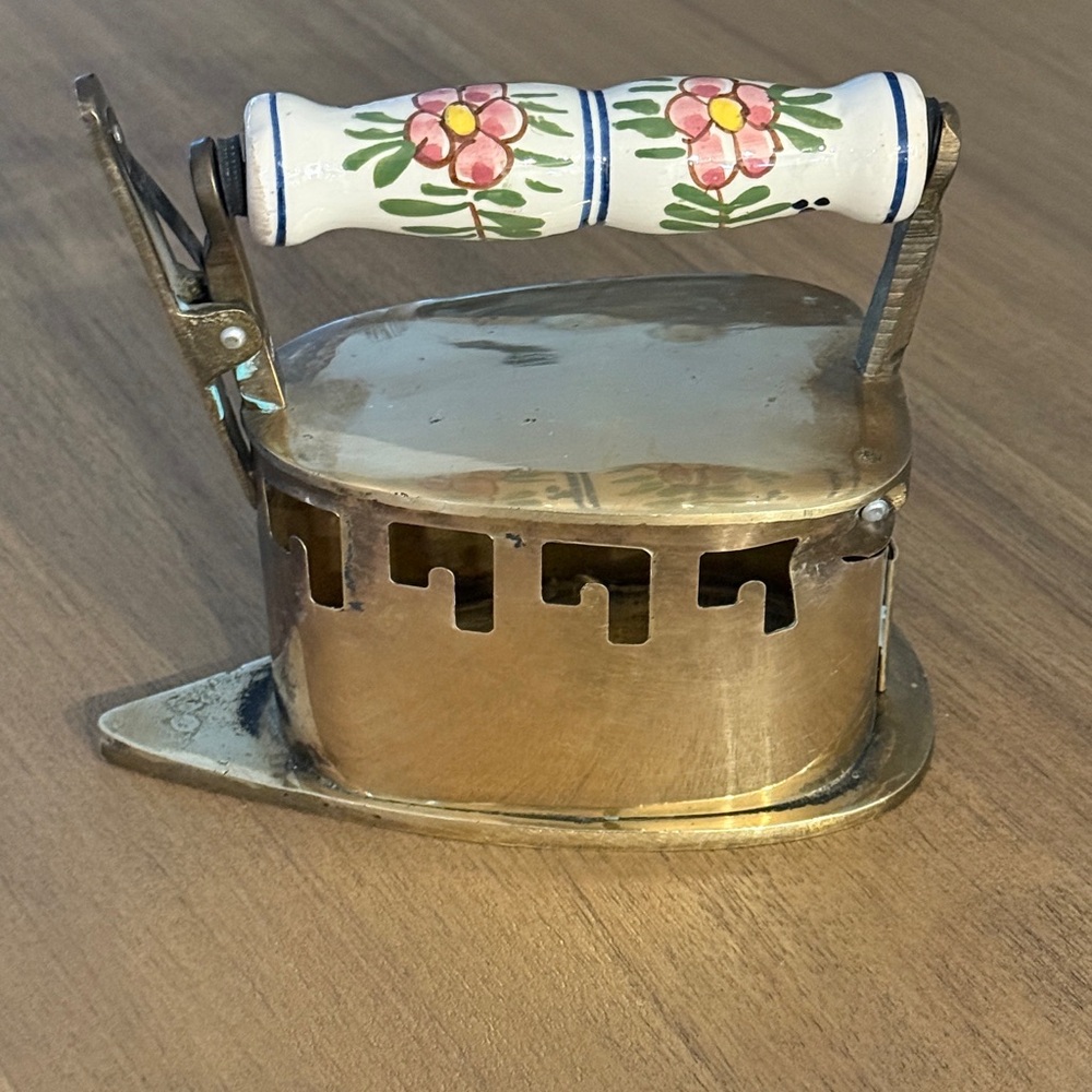 Vintage brass Dutch coal iron with a floral ceramic handle
